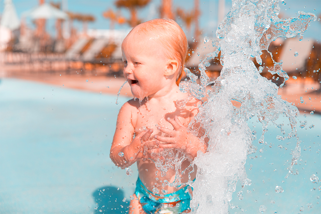 young child playing in pool