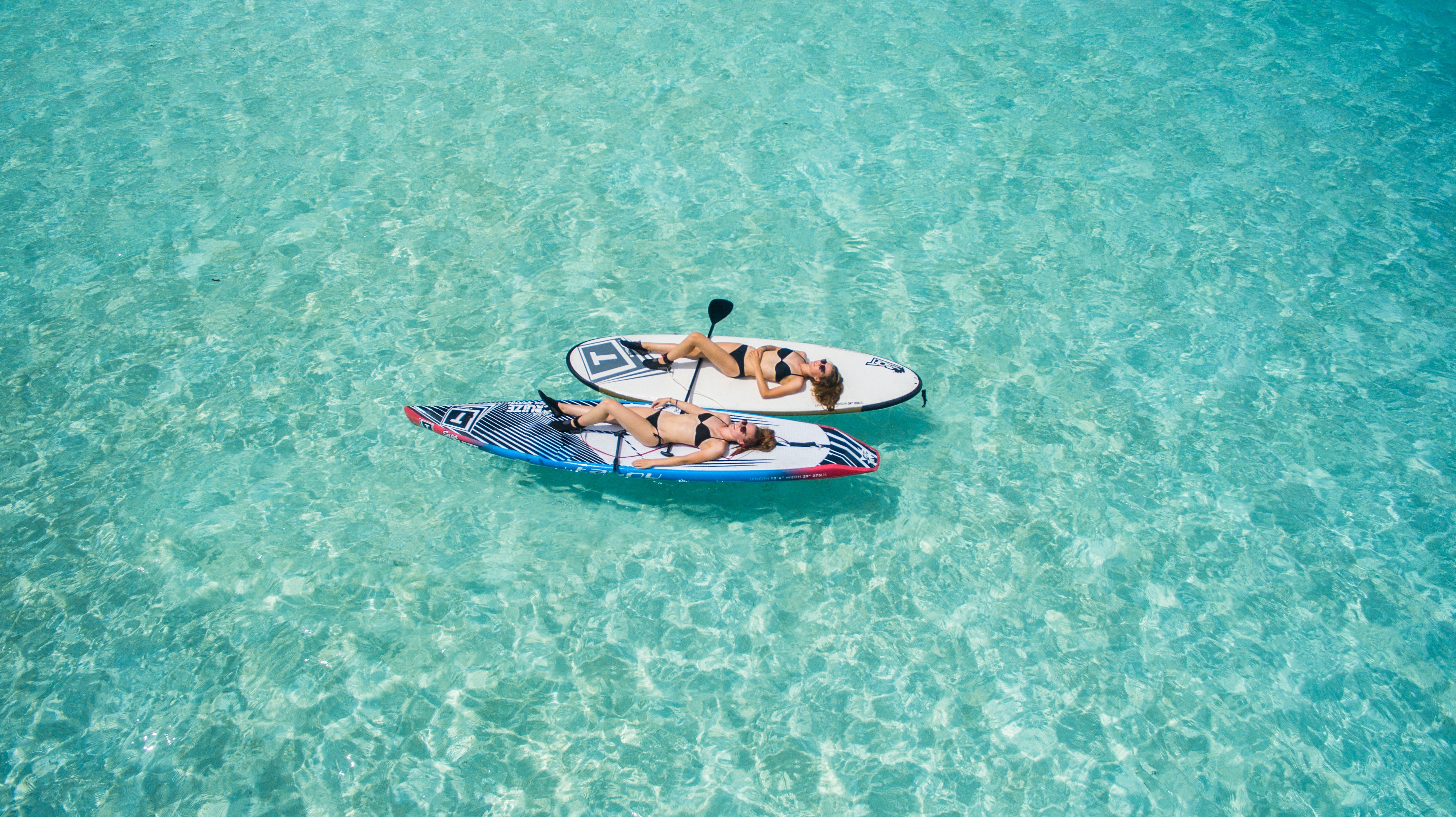 Girls paddleboarding in the Caribbean