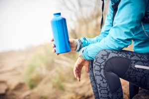 woman on a hike with her water bottle