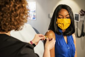 A woman received a bandaid after getting a vaccination