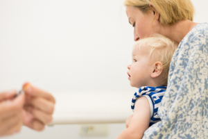 a baby about to get a vaccine